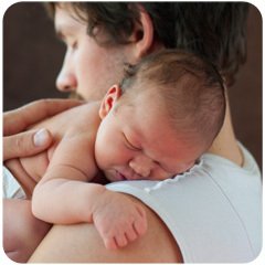 father holding baby